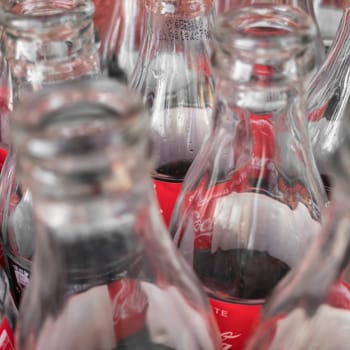 Empty glass bottles of Coca Cola, close-up. View from above. Italy February 19 2019.