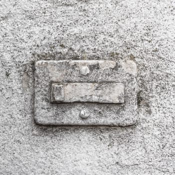 Broken doorbell, covered in paint, on a grungy wall with cracks and molds. Ideal for creative backgrounds.