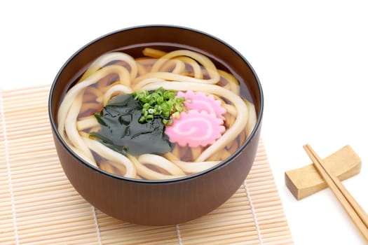 Japanese Kake udon noodles in a bowl on white background