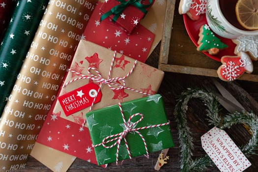 Wrapping little presents with colorful paper for Christmas holidays
