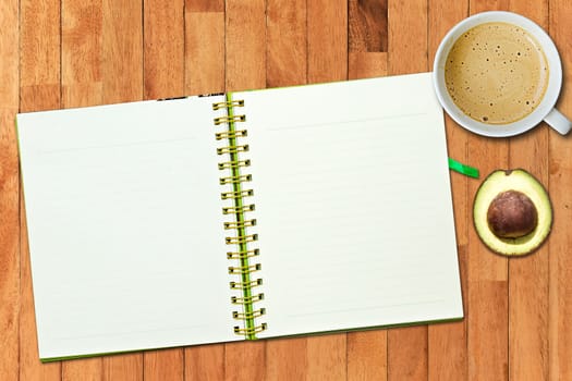Open notebook with blank pages and coffee cup on vintage wood background.Flat lay.