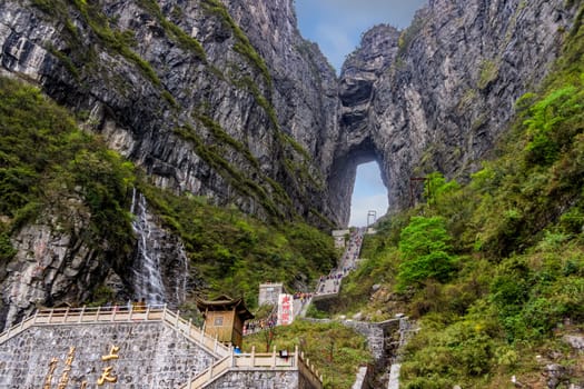Zhangjiajie, Hunan, China Apr 2013 Tourists climbing 999 stairs to Haven Gate in Tianman Mountains. View from bottom platform on climbing people below
