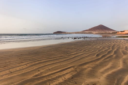 El Medano beach, in background La Montana Roja, Tenerife island, Spain