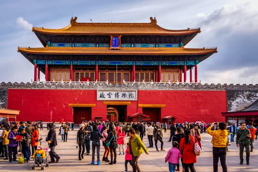 Beijing, China April 2013 Crowd of tourists visiting Forbidden City and taking pictures, front view on entrance