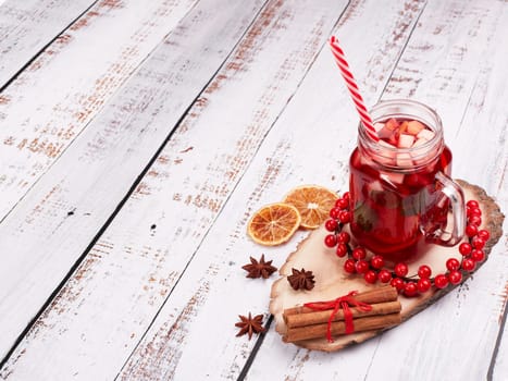 Still life with fruit tea, spices and oranges standing on light wooden background. Top view with copy space. New Year and Christmas treat. Winter vacation.