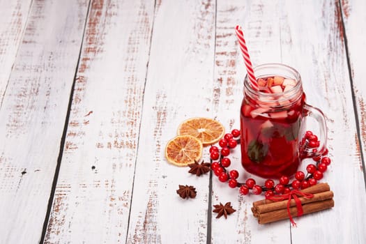 Still life with fruit tea, spices and oranges standing on light wooden background. Top view with copy space. New Year and Christmas treat. Winter vacation.