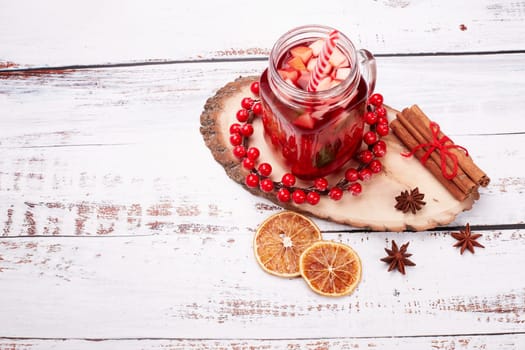 Still life with fruit tea, spices and oranges standing on light wooden background. Top view with copy space. New Year and Christmas treat. Winter vacation.