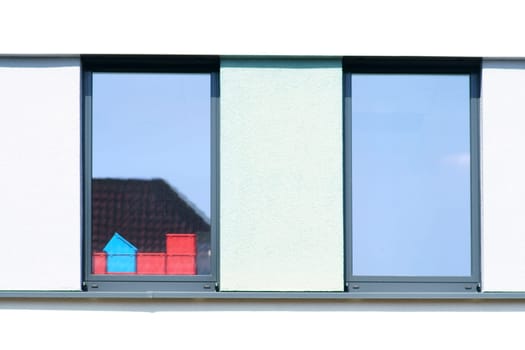 Plastic containers stand behind a window of a business building.....
