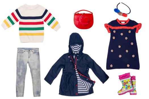 Collage set of little girl clothes isolated on a white background. The collection of a denim jeans or pants, sweater, a rain jacket and rubber boots, handbag and a colorful hairband. Autumn and spring fashion.