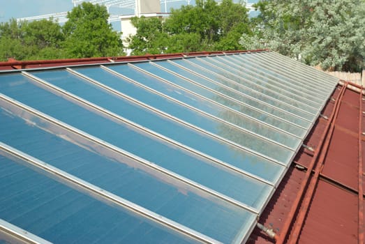 Solar water heating cells on the red roof. Gelio panels.