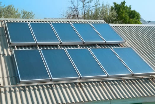 Solar water heating cells on the red roof. Gelio panels.