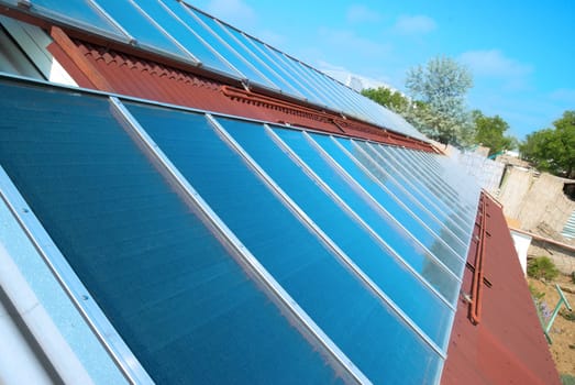 Solar water heating cells on the red roof. Gelio panels.