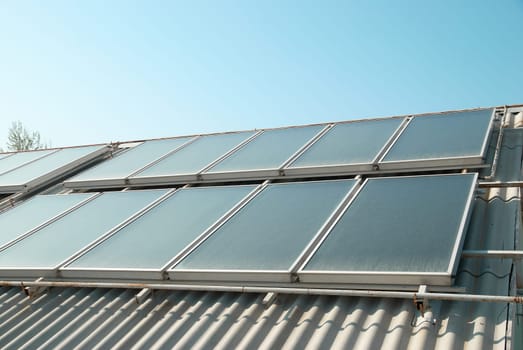 Solar water heating cells on the red roof. Gelio panels.