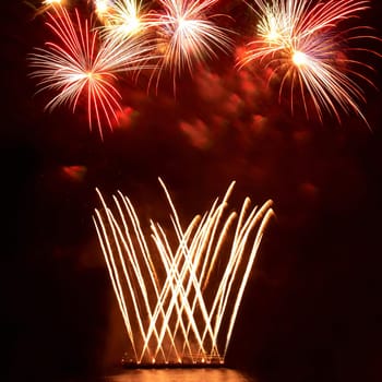 Colorful holiday fireworks on the black sky background.
