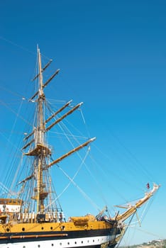 Beautiful sailing vessel with big masts on the mooring