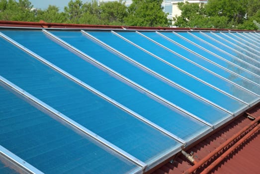 Solar water heating cells on the red roof. Gelio panels.