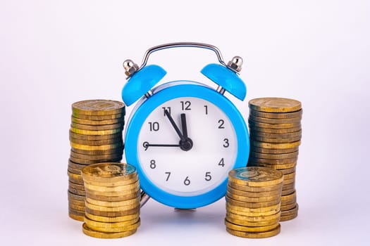 Clock and stacks of coins close-up