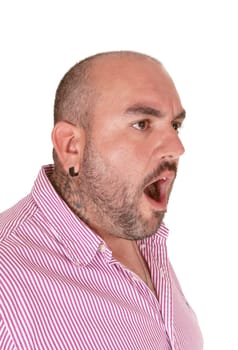 A very angry middle age Hispanic man in a red shirt shouting with his.mouth open in close-up, isolated for white background.