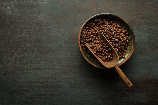 Roasted Coffee beans on dark table. Copyspace for your concept text