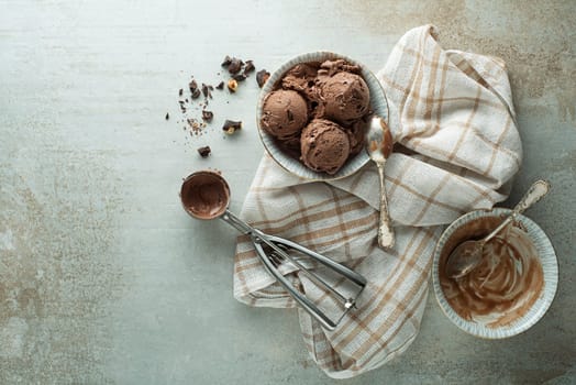 Chocolate ice cream scoop, scooped out of a container with a utensil