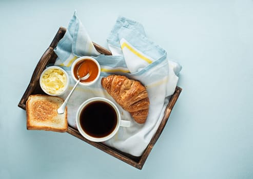 Breakfast served with coffee, croissant, bread, jam and butter. Continental delicious healthy breakfast