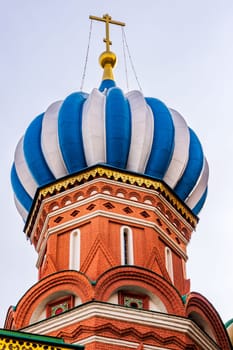 Closeup of blue and white dome on St. Basils Cathedral on the Red Square beautifully highlighted by sun at sunrise, golden hour, Moscow, Russia