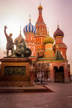Moscow, Russia, April 2013 Monument to Minin and Pozharsky and St. Basils Cathedral on the Red Square beautifully highlighted by sun at sunrise