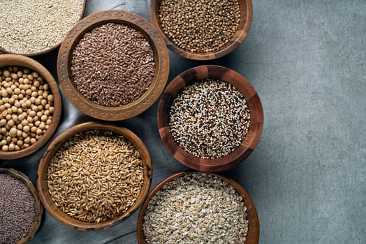 Various of healthy seeds and cereals - sesame, flax seed, chia seeds, soybean, buckwheat, psyllium, wheat and oats. Copy space.
