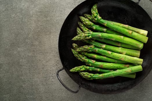 Fresh of green Asparagus. Cooking healthy meal in pan. Bunches of green asparagus