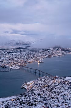 Aerial view to the city of Tromso in winter from the mountain ledge Storsteinen, 421 m above sea level , Northern Norway