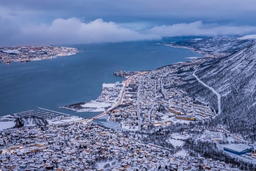 Aerial view to the city of Tromso in winter from the mountain ledge Storsteinen, 421 m above sea level , Northern Norway