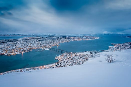 Aerial view to the city of Tromso in winter from the mountain ledge Storsteinen, 421 m above sea level , Northern Norway