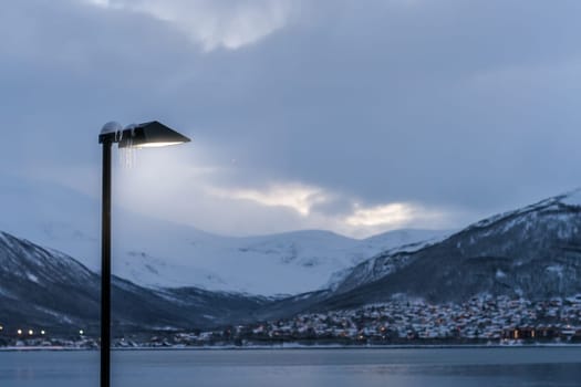 Port and harbour with famous Tromso Bridge across Tromsoysundet strait in the background, Northern Norway