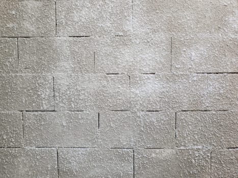 Old grey stone masonry wall texture made of foam blocks or airblocks. Abstract surface plastered. Grunge, weathered construction structure.