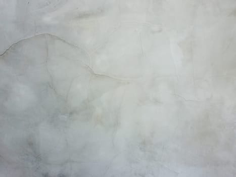 Abstract surface off smooth, grey plaster wall with cracks and scratches. Old grungy, weathered construction structure, dirty texture.