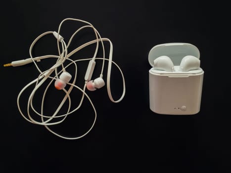 Comparison between tangled wired headphones versus wireless earphones for music listening. Pros and cons, opposite contrary. Technology development tendencies, human entertainment conveniences concept