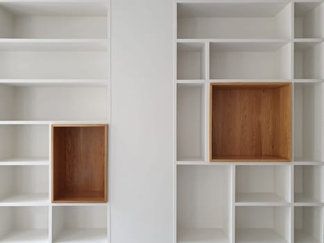 Empty closet shelves background. Modern wooden wardrobe boxes, beautiful white and brown interior design combination, abstract shape and patterns.