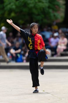 Columbus, Ohio, USA - May 26, 2019: Columbus Asian Festival, Franklin Park, young woman wearing traditional chinese clothing performing a display from Wushu Academy martial arts