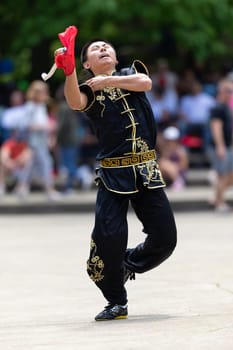 Columbus, Ohio, USA - May 26, 2019: Columbus Asian Festival, Franklin Park, Man wearing traditional chinese clothing handling a Kungfu broadsword during the festival