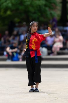 Columbus, Ohio, USA - May 26, 2019: Columbus Asian Festival, Franklin Park, young woman wearing traditional chinese clothing performing a display from Wushu Academy martial arts