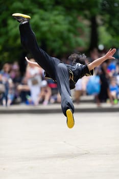 Columbus, Ohio, USA - May 26, 2019: Columbus Asian Festival, Franklin Park, Chinese man wearing traditional clothing displaying his martial arts skill