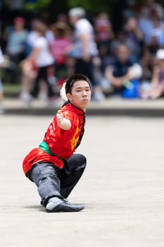 Columbus, Ohio, USA - May 26, 2019: Columbus Asian Festival, Franklin Park, Chinese boy wearing traditional chinese traditional clothing, performing a display of chinese martial arts