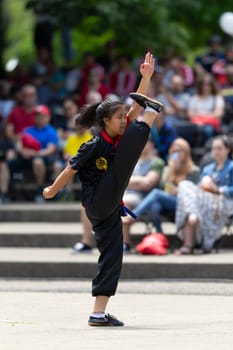 Columbus, Ohio, USA - May 26, 2019: Columbus Asian Festival, Franklin Park, young woman wearing traditional chinese clothing performing a display from Wushu Academy martial arts