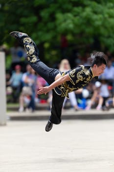 Columbus, Ohio, USA - May 26, 2019: Columbus Asian Festival, Franklin Park, Chinese man wearing traditional clothing displaying his martial arts skill
