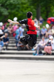 Columbus, Ohio, USA - May 26, 2019: Columbus Asian Festival, Franklin Park, Chinese boy wearing traditional chinese traditional clothing, performing a display of chinese martial arts