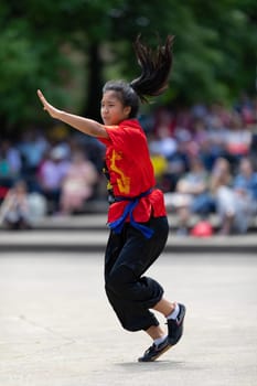 Columbus, Ohio, USA - May 26, 2019: Columbus Asian Festival, Franklin Park, young woman wearing traditional chinese clothing performing a display from Wushu Academy martial arts