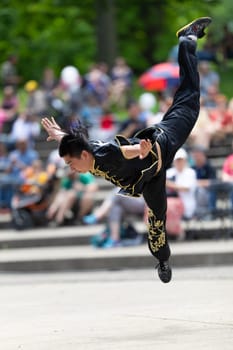 Columbus, Ohio, USA - May 26, 2019: Columbus Asian Festival, Franklin Park, Chinese man wearing traditional clothing displaying his martial arts skill