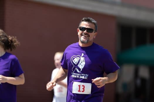 Buckhannon, West Virginia, USA - May 18, 2019: Strawberry Festival, Man smiling for the camera, runing participating in a race prior to the parade