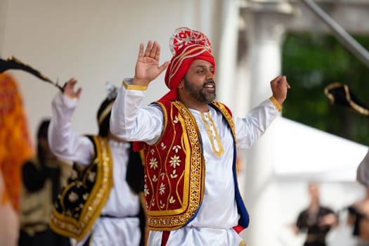 Columbus, Ohio, USA - May 26, 2019: Columbus Asian Festival, Indian men wearing traditional clothing, performing Bhangra traditional dance in the amphitheater at Franklin Park