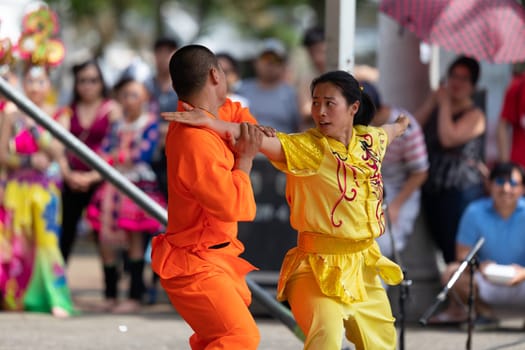 Columbus, Ohio, USA - May 26, 2019: Columbus Asian Festival, Chinese Men and women performing a display of shaolin martial arts in the amphitheater at Franklin Park